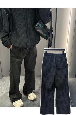 バレンシアガ チェック柄のワイドレッグパンツ