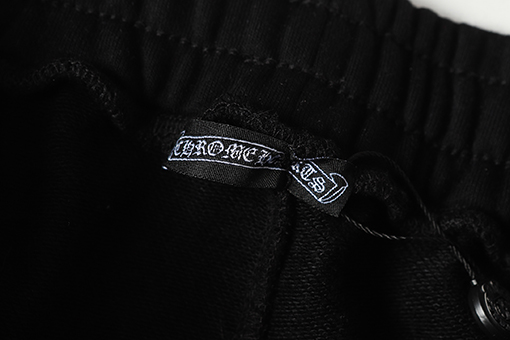 クロムハーツ サンスクリット文字プリントの白いカジュアルパンツ